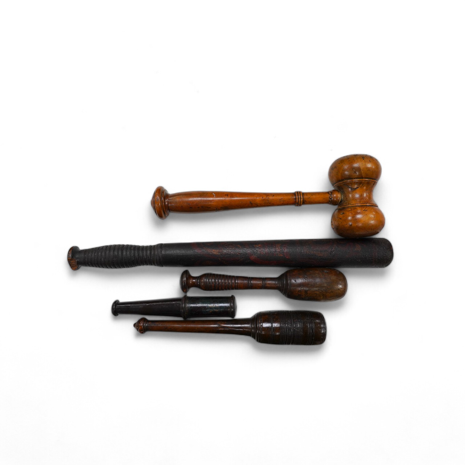 A large fruitwood gavel, a truncheon, a lead-weighted cosh and two others, longest 42cm. Condition - fair